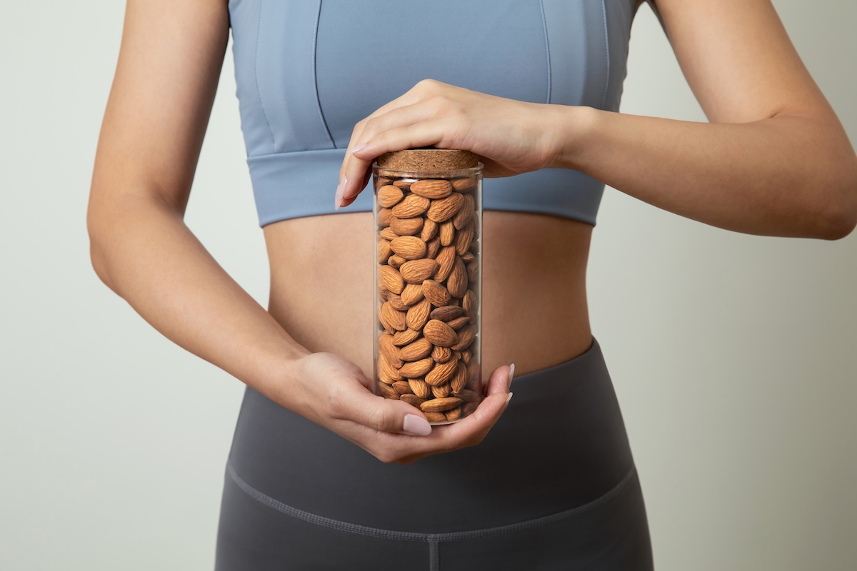 Woman holding a tube of almonds